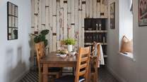At the far side of the kitchen sits a rustic dining table for six