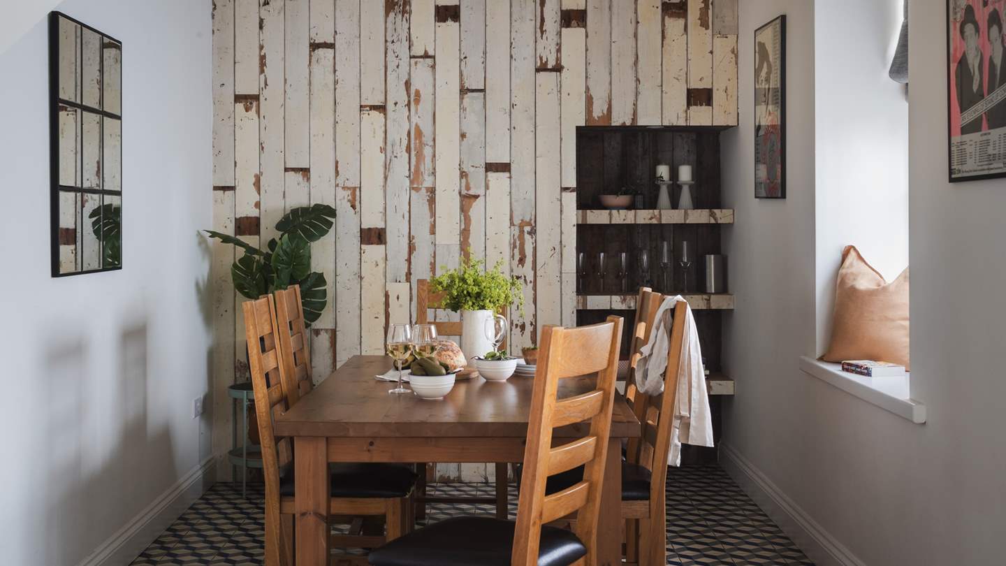At the far side of the kitchen sits a rustic dining table for six