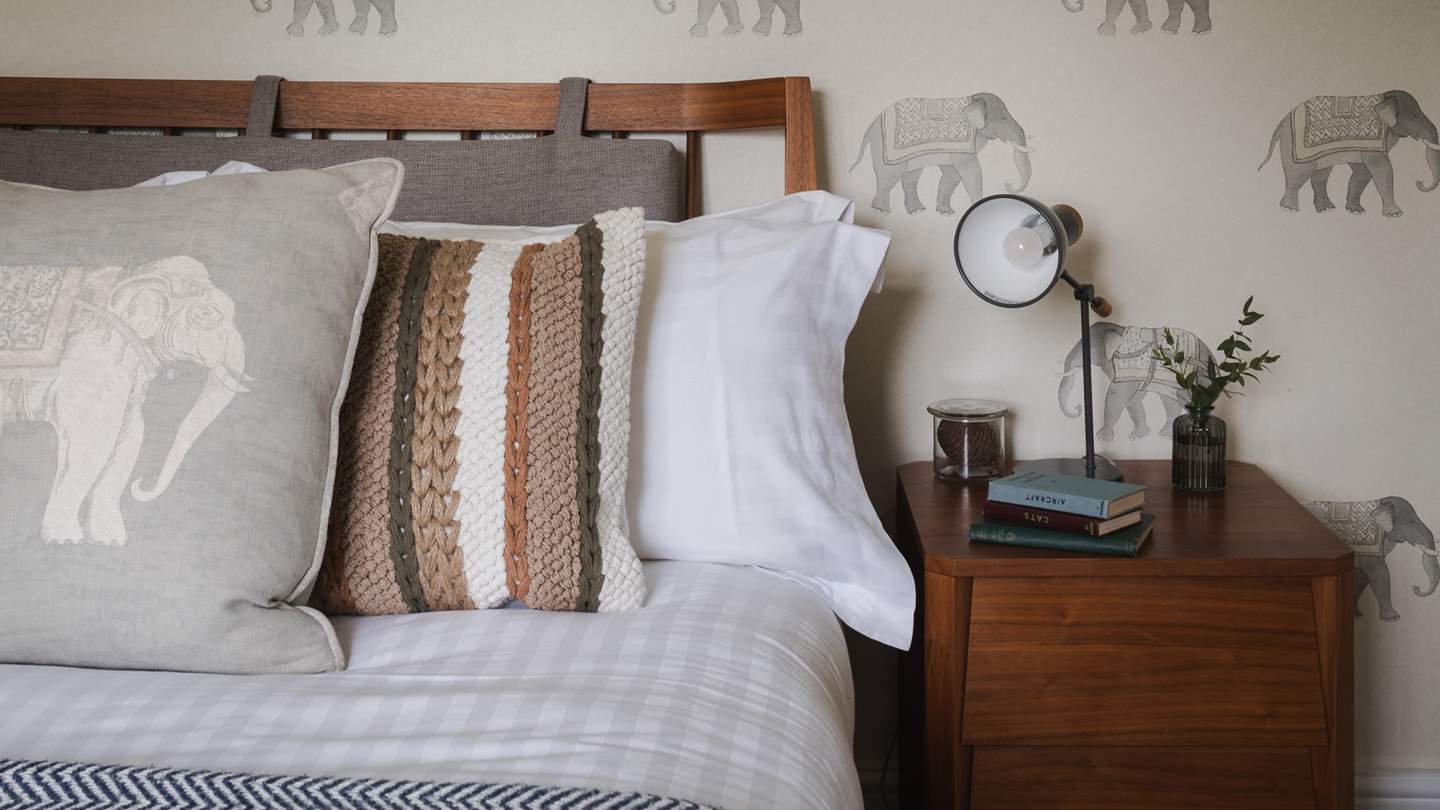A double bed and bedside tables beautifully complement the mid-century style headboard
