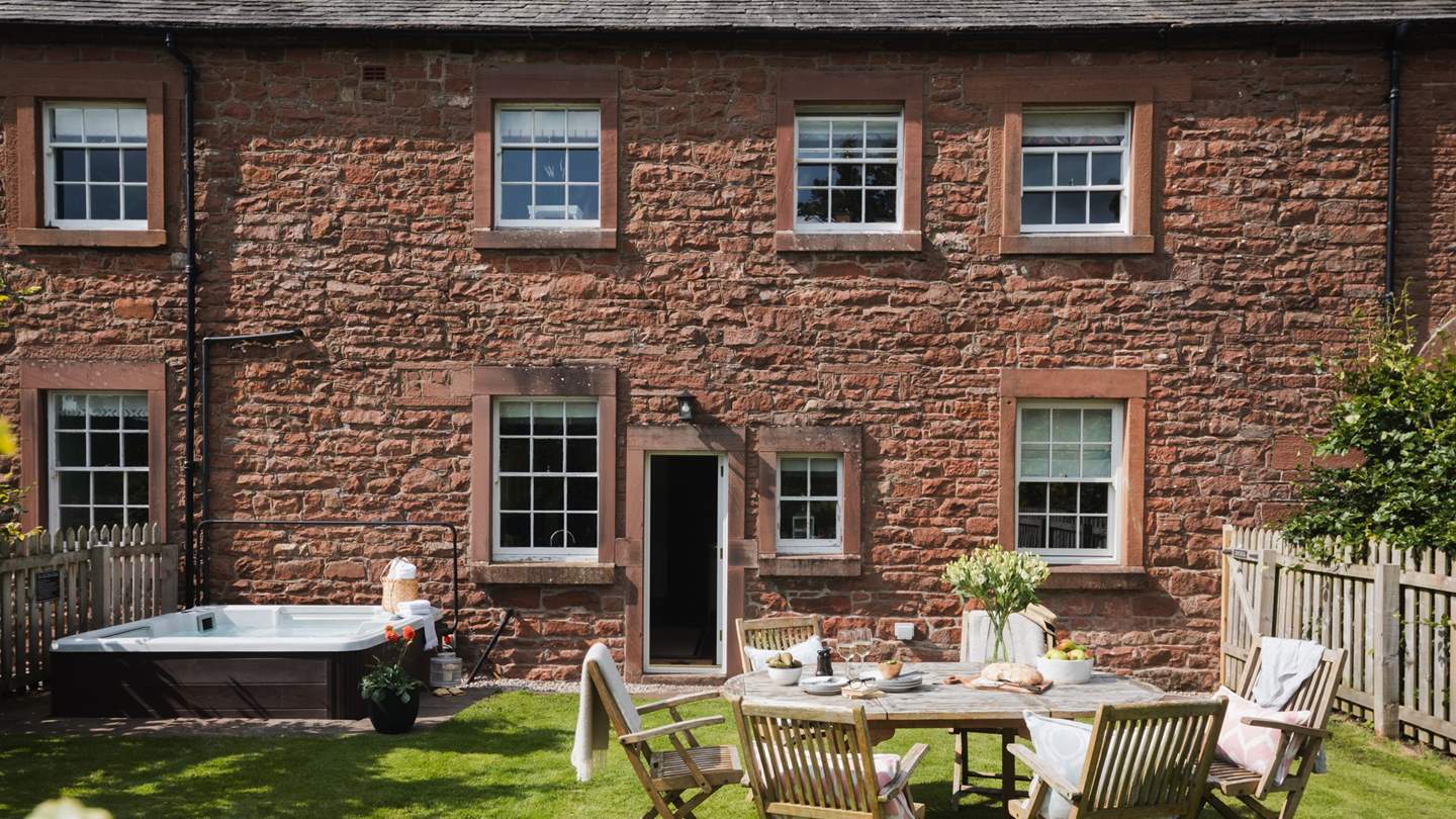 Step outside to uncover a tranquil lawned garden, complete with a bubbling hot tub 