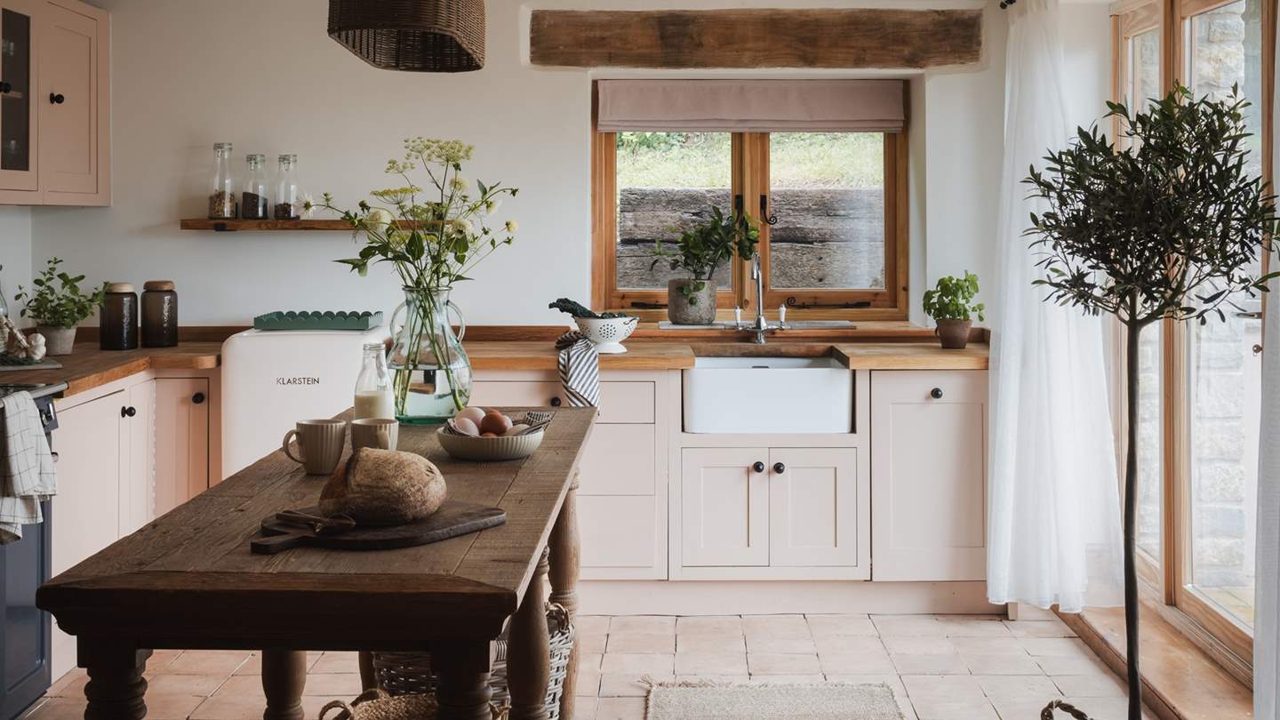 A heavenly neutral palette is enhanced with pastel pinks and rustic interior touches