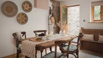 Step into the traditional country kitchen and dining space, complete with gorgeous antique furniture