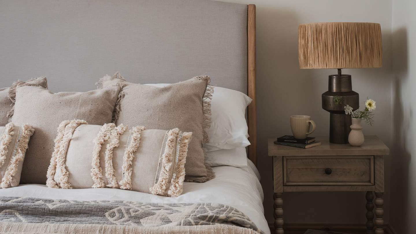 Here you’ll find a king-sized bed dressed in an array of cosy linens, 