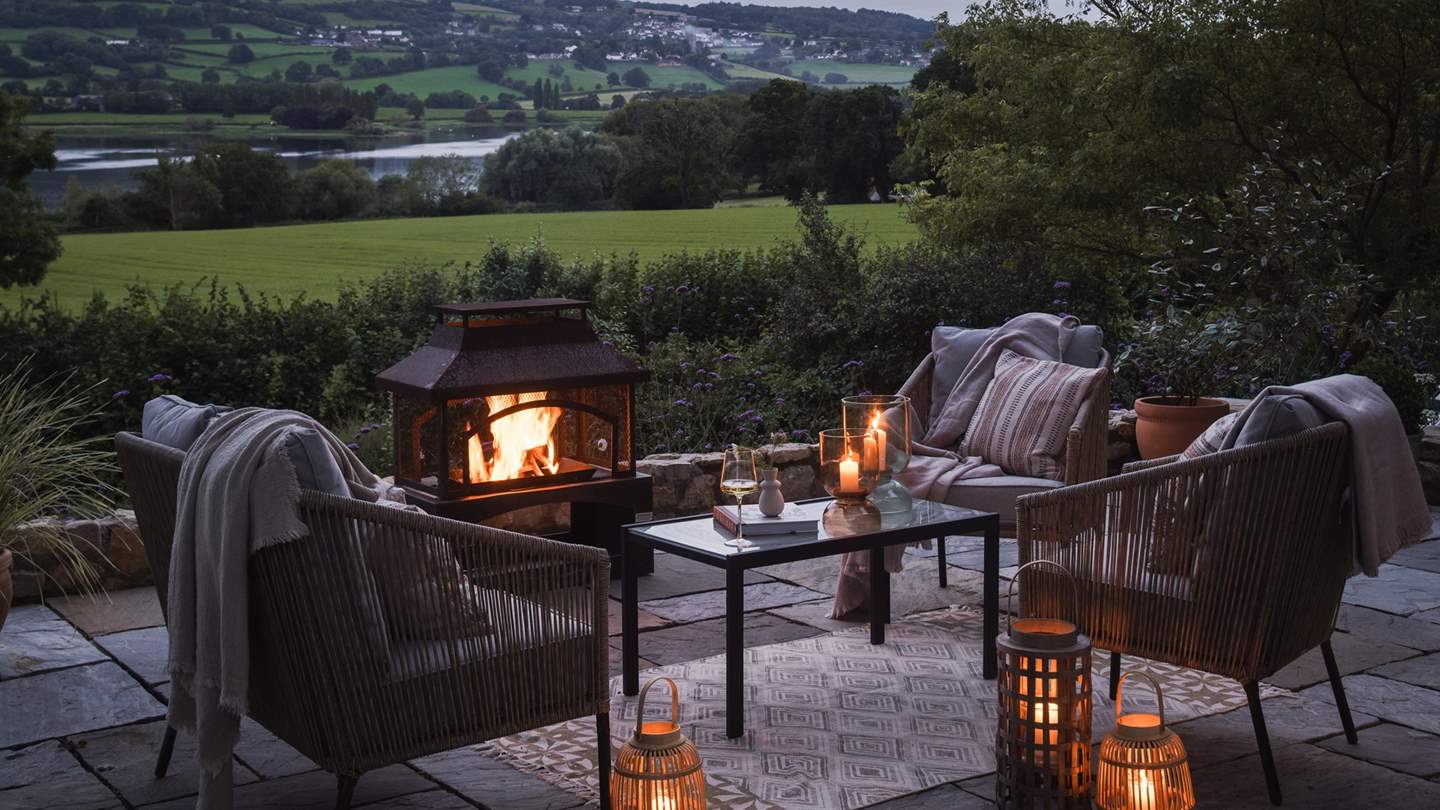 At the front of the cottage, a romantic firepit awaits with a table and chairs positioned to gaze over rolling countryscapes