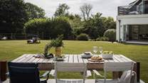 Meanwhile in front of the summerhouse a sun-kissed patio beckons for dreamy moments of alfresco living
