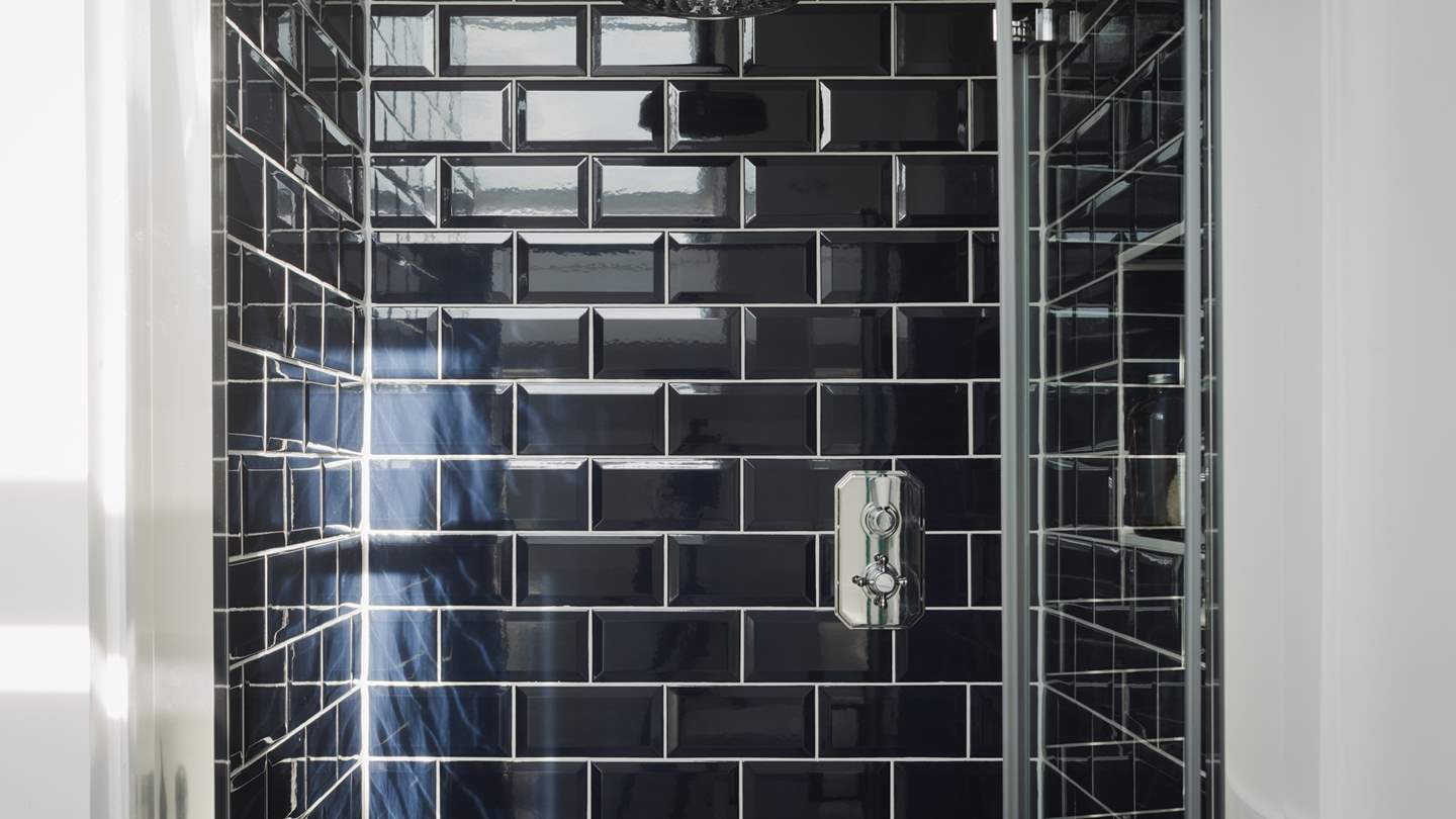 These two bedrooms share a bathroom with a shower