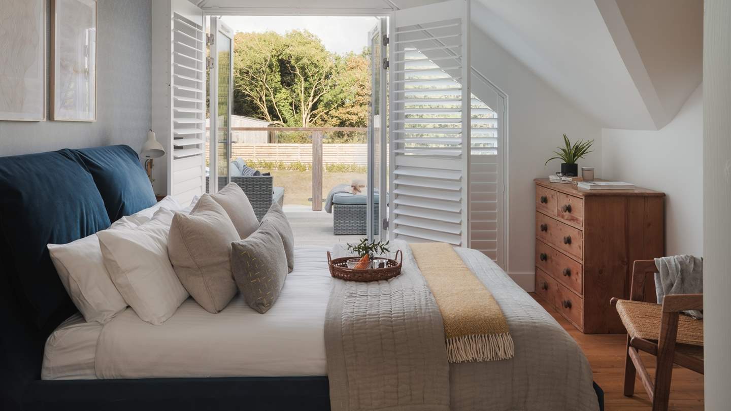 Located on the first floor, the stunning master suite enjoys a beautiful aspect overlooking the garden and flurry of trees beyond