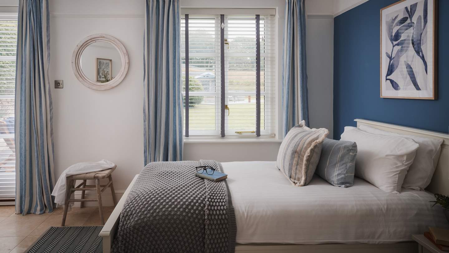 Awaiting on the ground floor, the fourth bedroom is a delightful space with twin beds