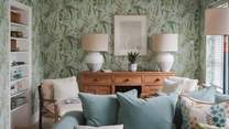 The gorgeous lounge of this rural treat harmonises with nature, adorned with Nina Cambell wallpaper 