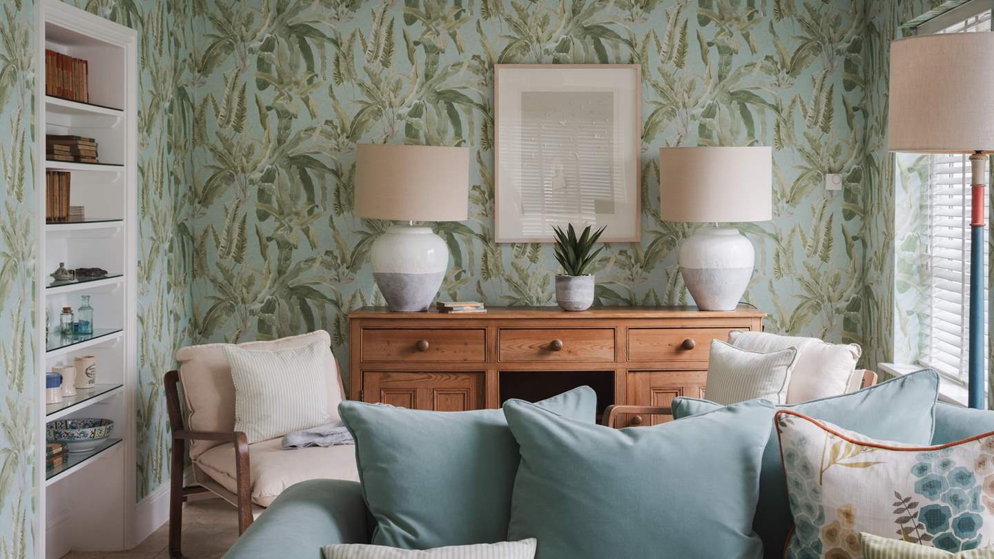The gorgeous lounge of this rural treat harmonises with nature, adorned with Nina Cambell wallpaper 