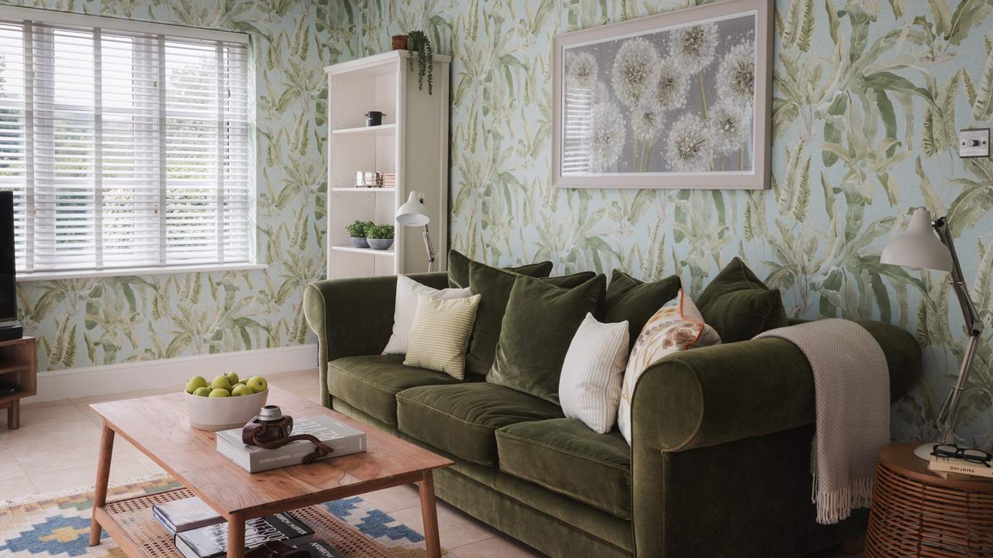 Ensuring year-round appeal, large patio doors provide a window to the elements in winter, and open in summer to let balmy breezes drift into the room