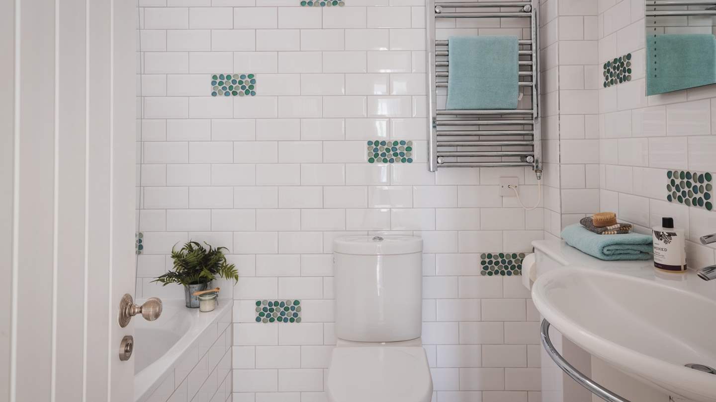 This bedroom also benefits from an ensuite bathroom set opposite the room with a bath with a separate shower head