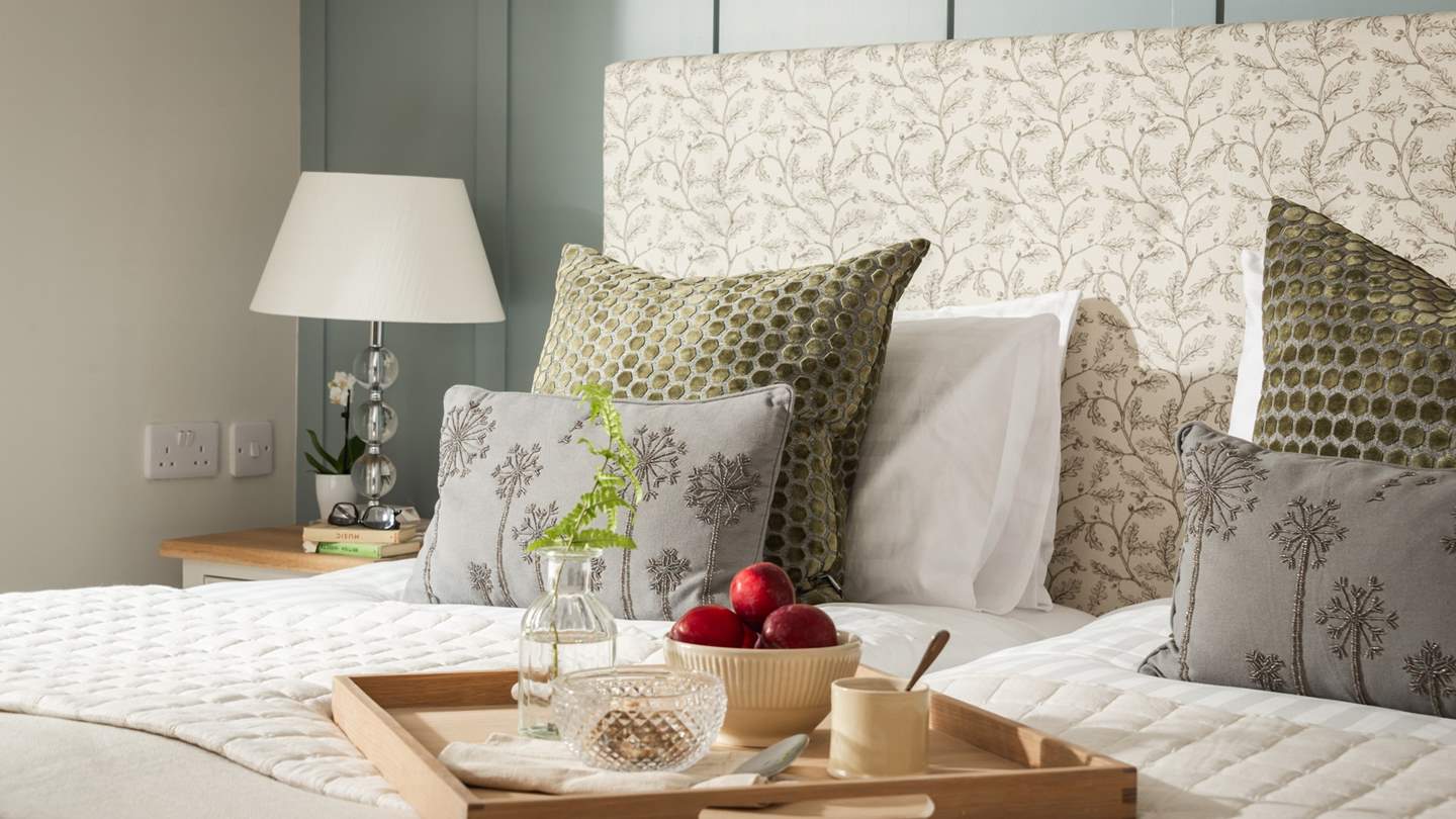 Stylishly curated, it is furnished with two bedside tables and features large drawers and ample hanging space for belongings