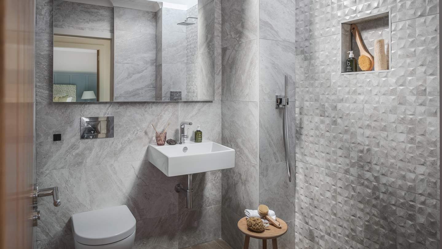 Across the hall, you will find a wet room with the addition of underfloor heating