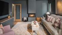 Cosy up on one of the large sofas or armchairs and enjoy the warmth of the three-sided fireplace