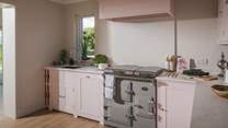 Tigh an Tobair’s Neptune Pink Peppercorn kitchen flows from the open-plan dining area and creates a wonderful space for preparing family repasts