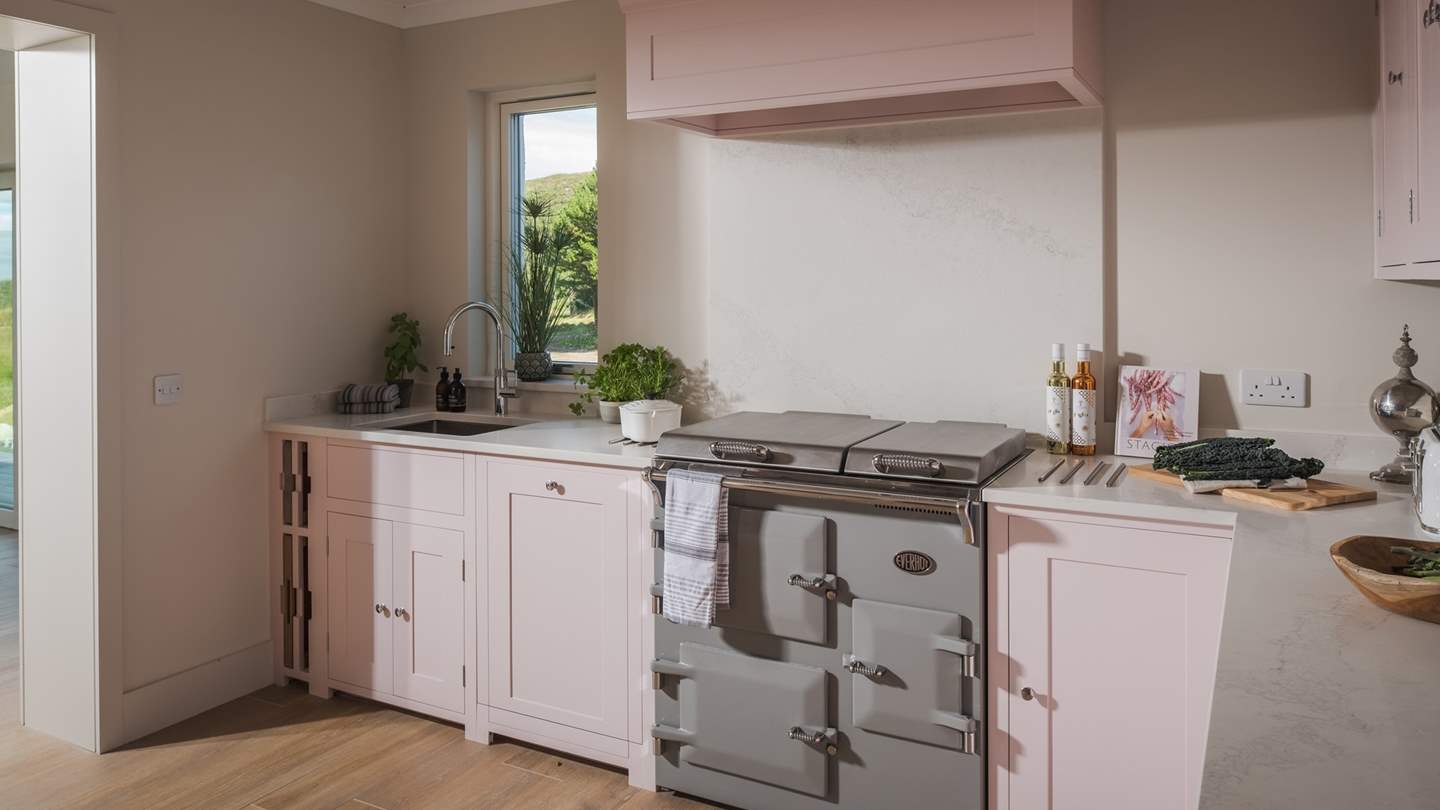 Tigh an Tobair’s Neptune Pink Peppercorn kitchen flows from the open-plan dining area and creates a wonderful space for preparing family repasts