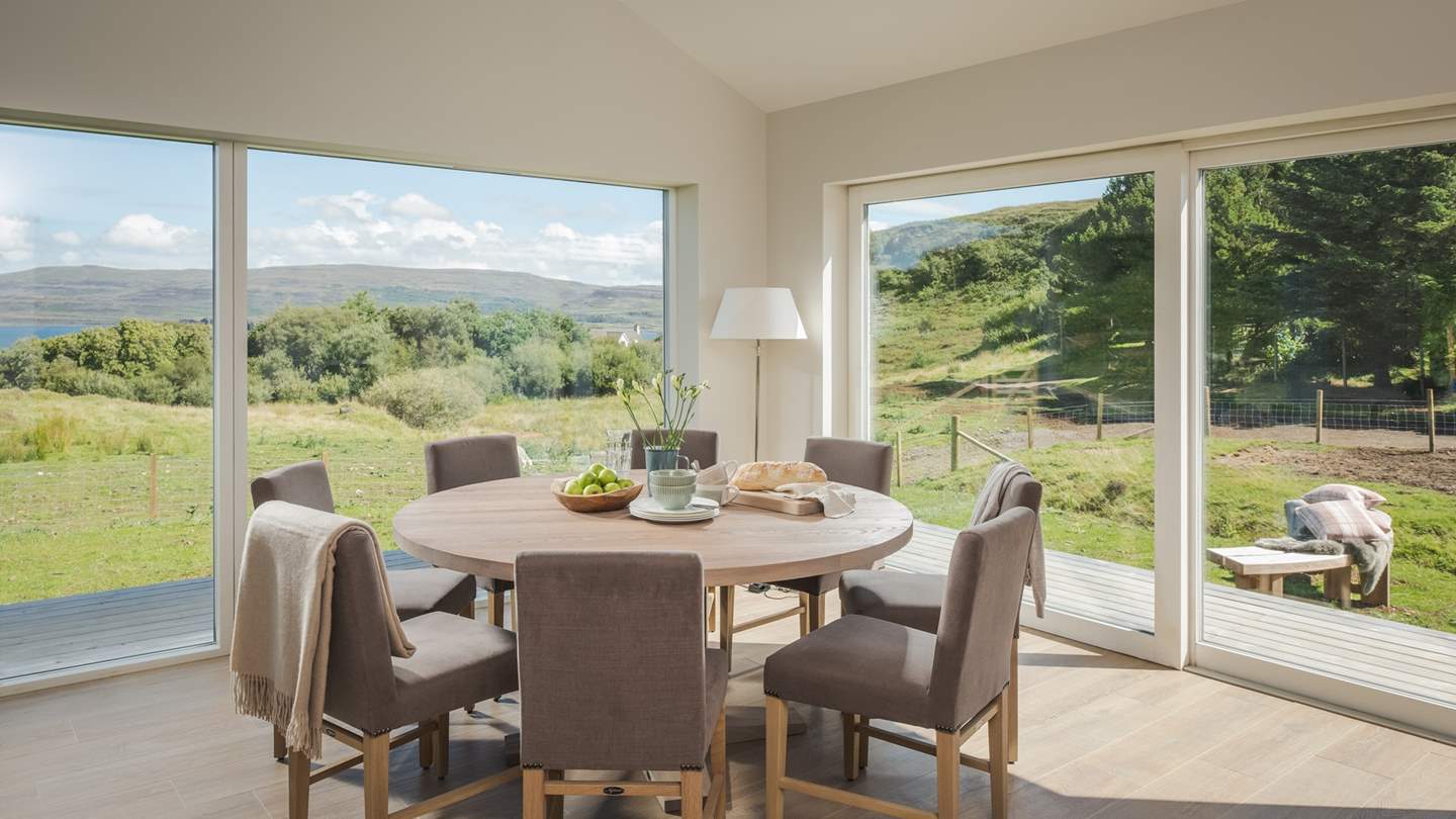 Ready to join guests over full plates and sparkling flutes, a round dining table takes pride of place next to the kitchen, overlooking the garden and the island beyond