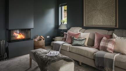 Stretch out in style in the gorgeous snug, where a spacious sofa is topped with elegant, pastel-toned cushions....