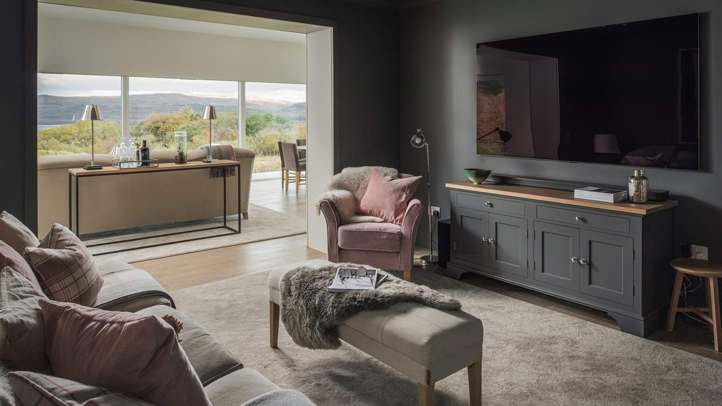 In the snug, you can find a 77-inch television perfect for movie nights with popcorn in hand... 