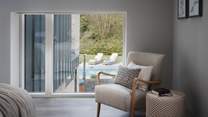 This room boasts views across the outdoor pool, igniting excitement for little ones eager to take a dip in the balmy cerulean water before them