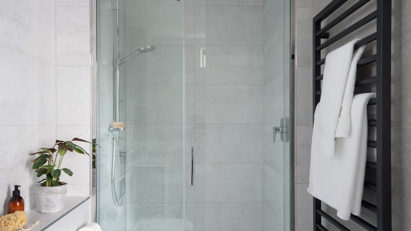 A fourth ensuite can be found tucked in the corner of the room, complete with a walk-in shower and a heated towel rail