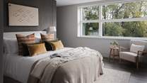 The third bedroom beckons with cushions in inviting shades 