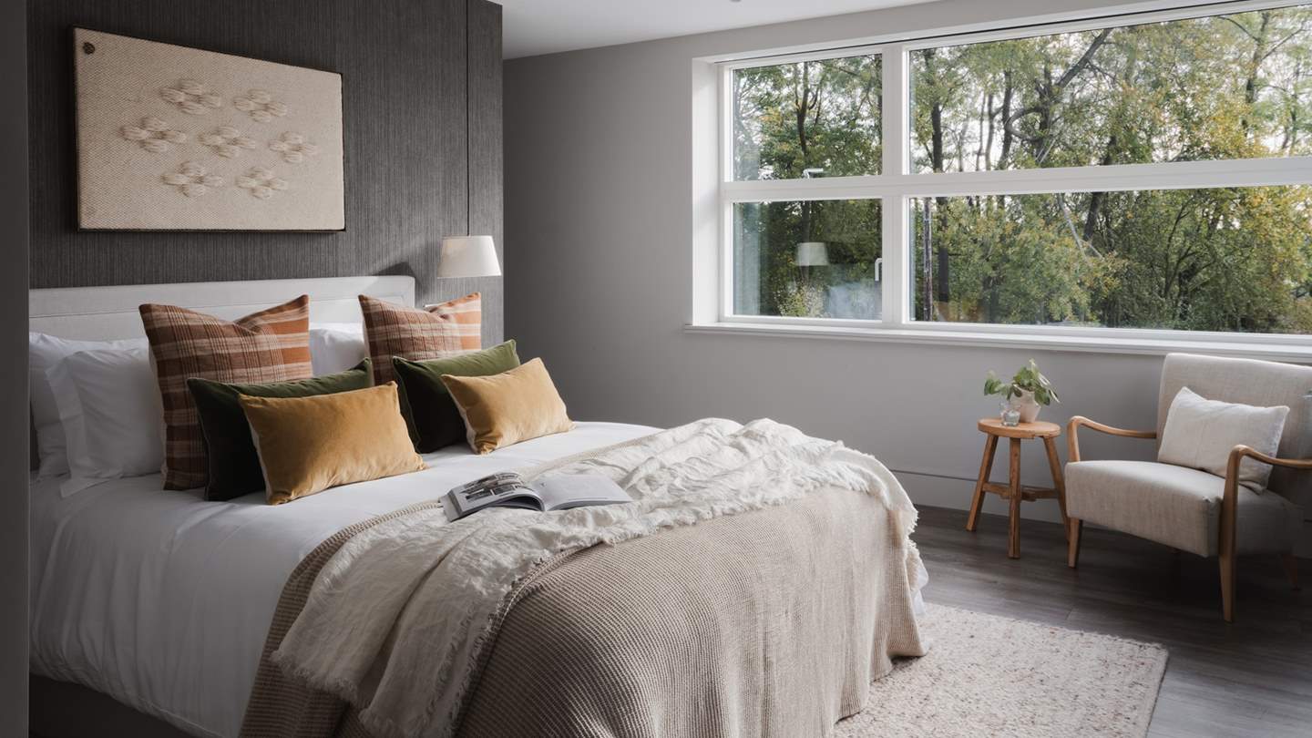 The third bedroom beckons with cushions in inviting shades 