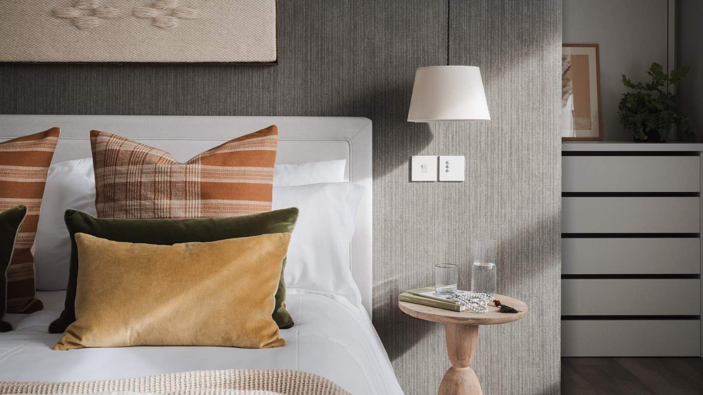 To the side of the bedroom, you’ll find a hidden walk-in wardrobe, complete with plenty of storage space alongside a dressing table for pampering moments