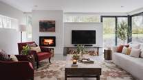 Settle in for snug evenings beside the Morso wood-burning stove