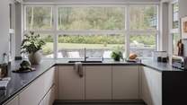 Large windows allow light to pour into the delightfully contemporary kitchen 