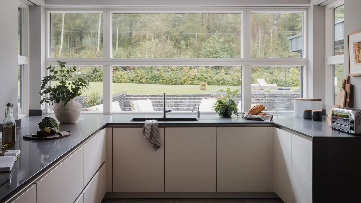 Large windows allow light to pour into the delightfully contemporary kitchen 
