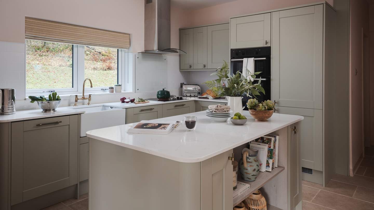The light-filled kitchen of Druimarbin Farmhouse proposes peaceful moments over soothing cups of coffee and social gatherings with sparkling flutes