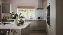 Cute and compact with a bespoke kitchen island, it cleverly incorporates an array of integrated appliances and useful additions