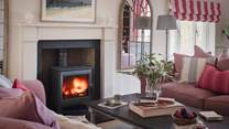 In winter, the cosy atmosphere is enhanced by the warming glow of the wood burning stove...