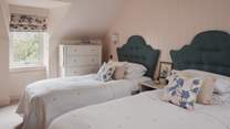 The second bedroom is a picturesque twin featuring two single beds topped with the highest quality sheets