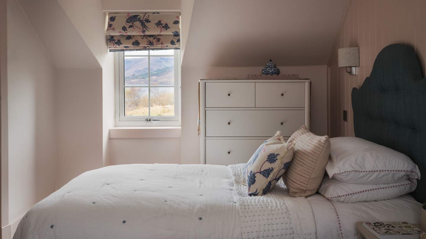 This space is tastefully finished with a large  chest of drawers and a spacious built-in hanging cupboard for stowing belongings