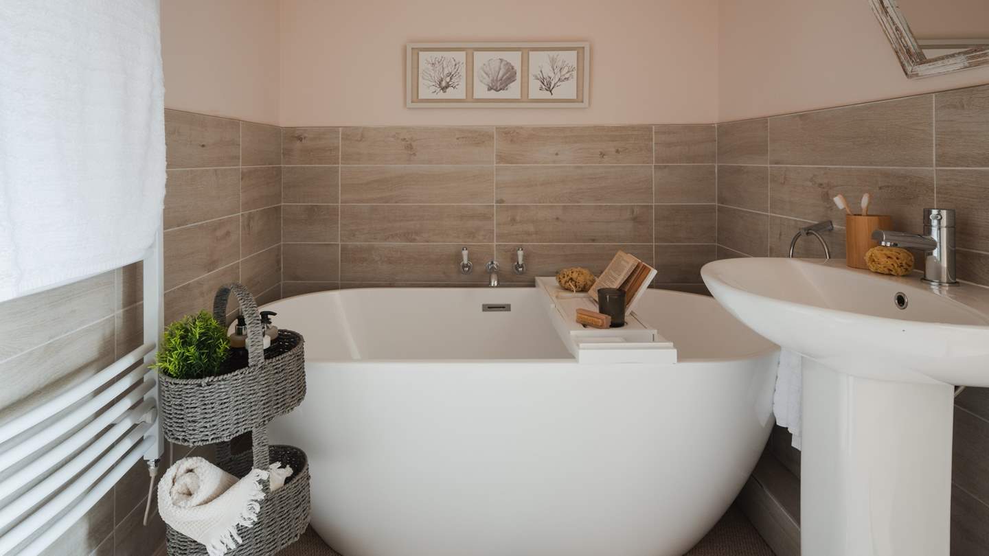 For added convenience, this bedroom boasts its own ensuite bathroom with an alcove window and delightful egg bath