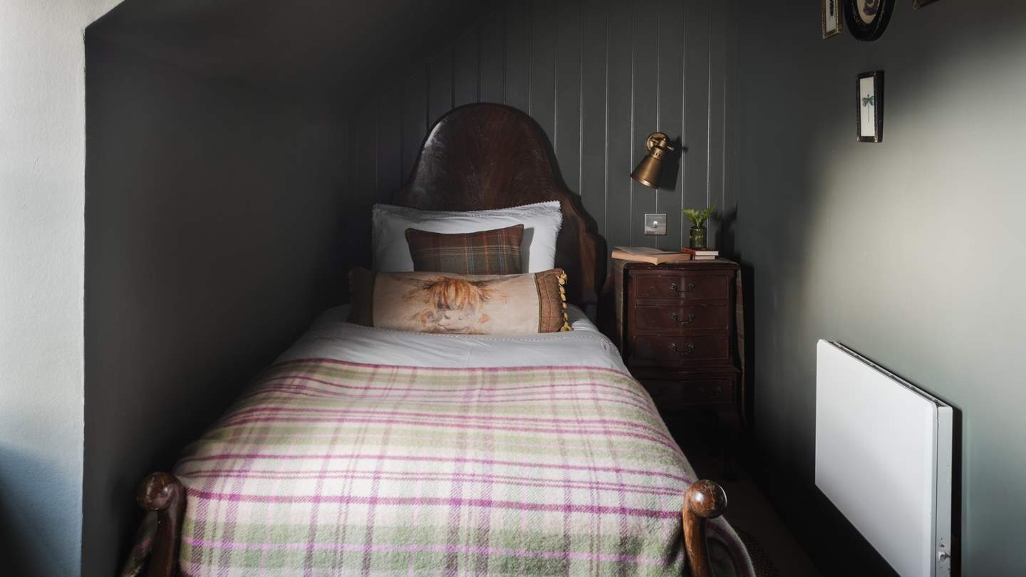 The adorable third bedroom is a dream in deep forest green