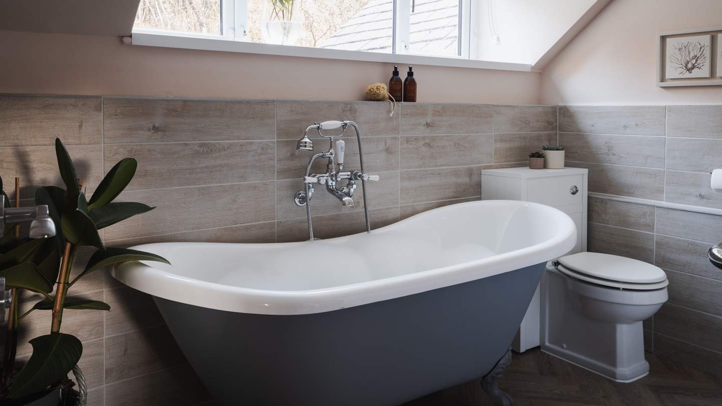 On the first floor, you'll find a sweet family bathroom, complete with a deep roll-top bath 