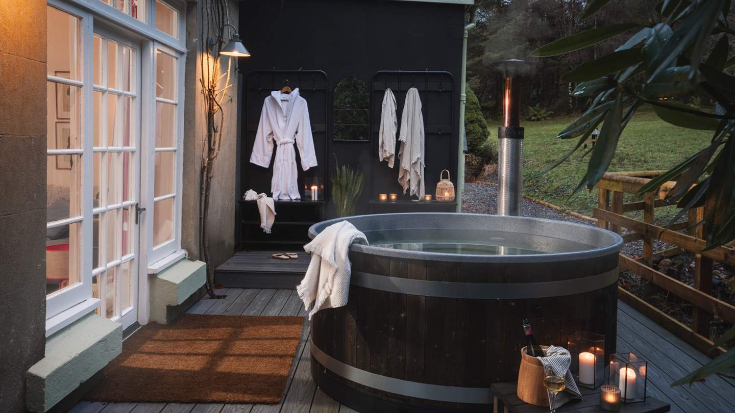 Calling for moments of ultimate relaxation, a heavenly wood-fired hot tub sits in a sheltered corner 