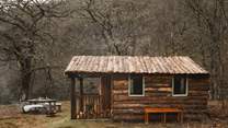Discover the cosy woodland cabin, shared with guests at Coruanan Farmhouse
