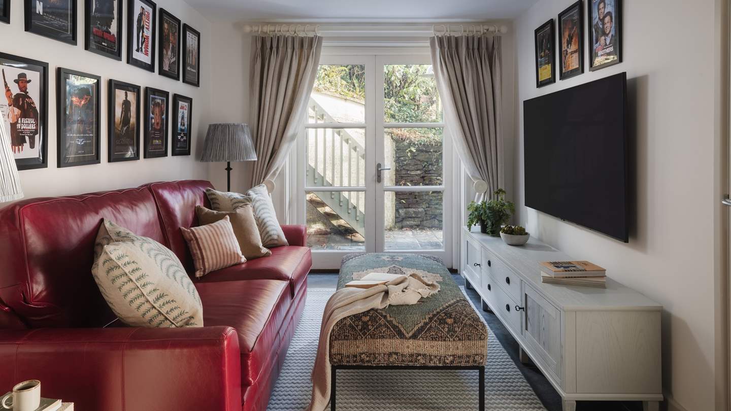 Perfect for movie nights, an additional snug-come-cinema room resides on the ground floor