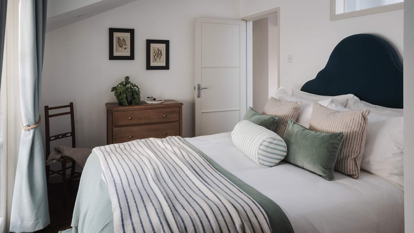 The fourth bedroom is centred around a sumptuous king bed facing floor-to-ceiling windows, with a private patio made for peaceful moments