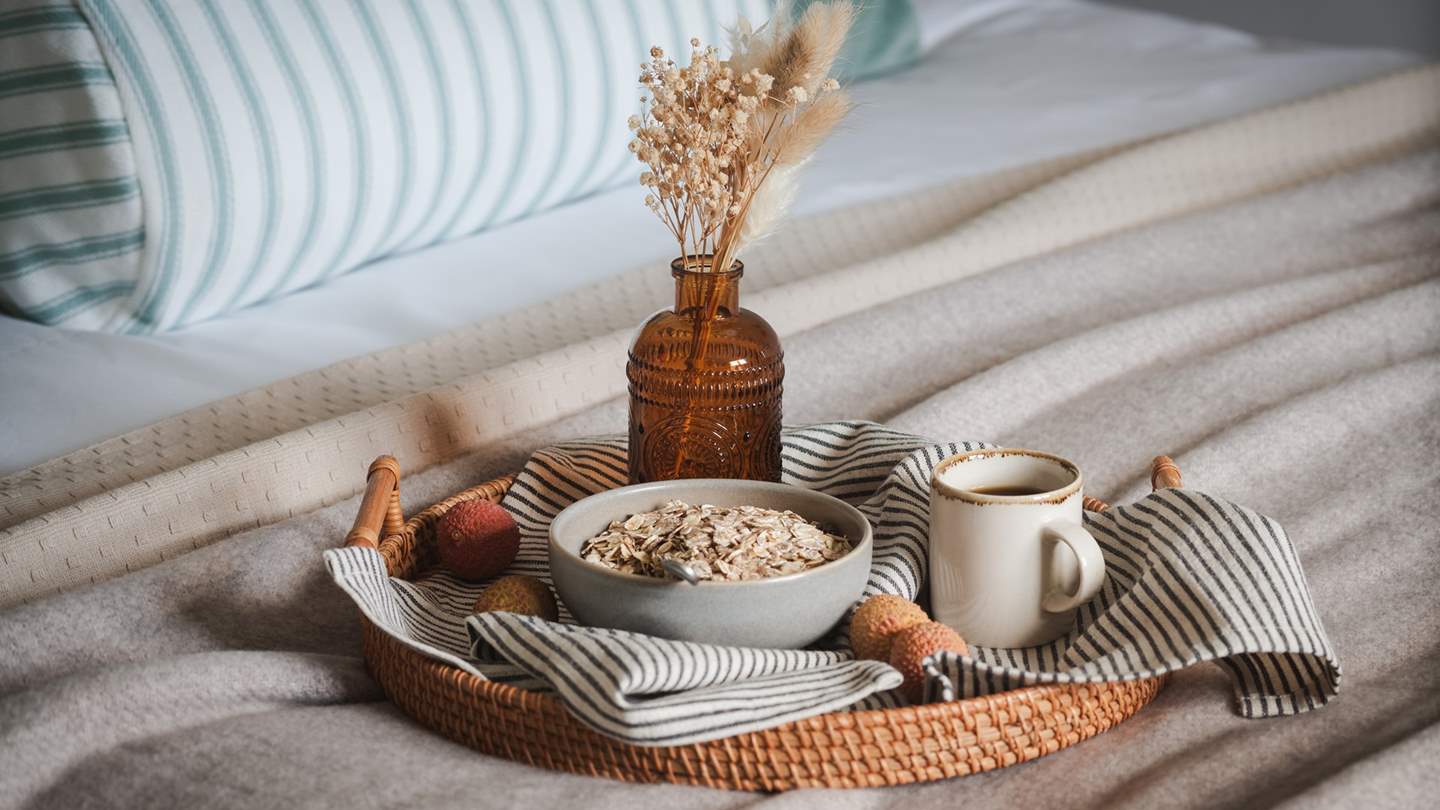 Painted wooden wainscoting draws the eye, while integrated fitted wardrobes provide space to stow treasures