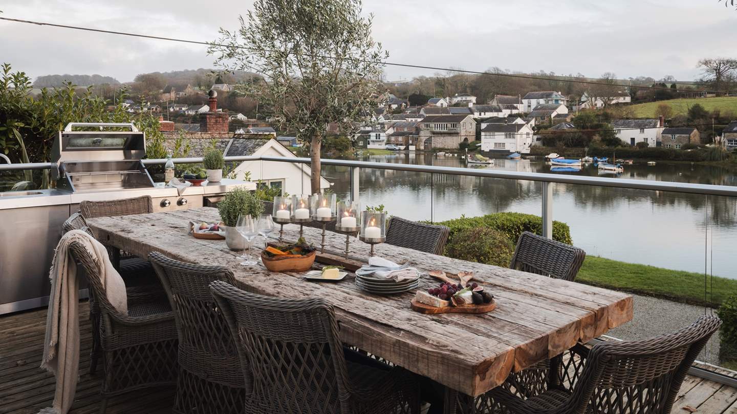 Styled with a family dining table and chairs and comfortable lounge seating, it also boasts an outdoor kitchen with a barbecue, fridge and sink 