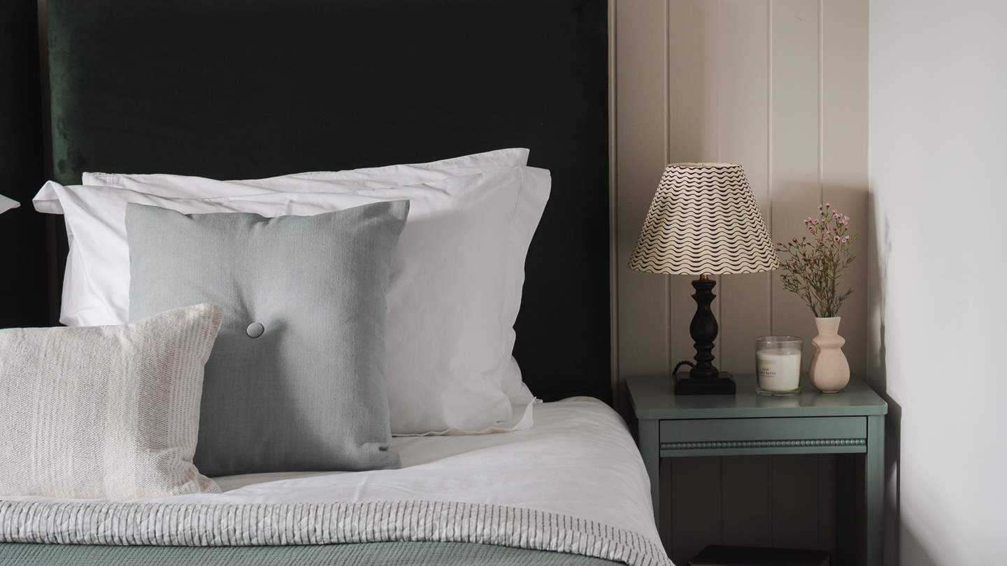 Enswathing the bed are the finest linens and super-soft pillows and throws