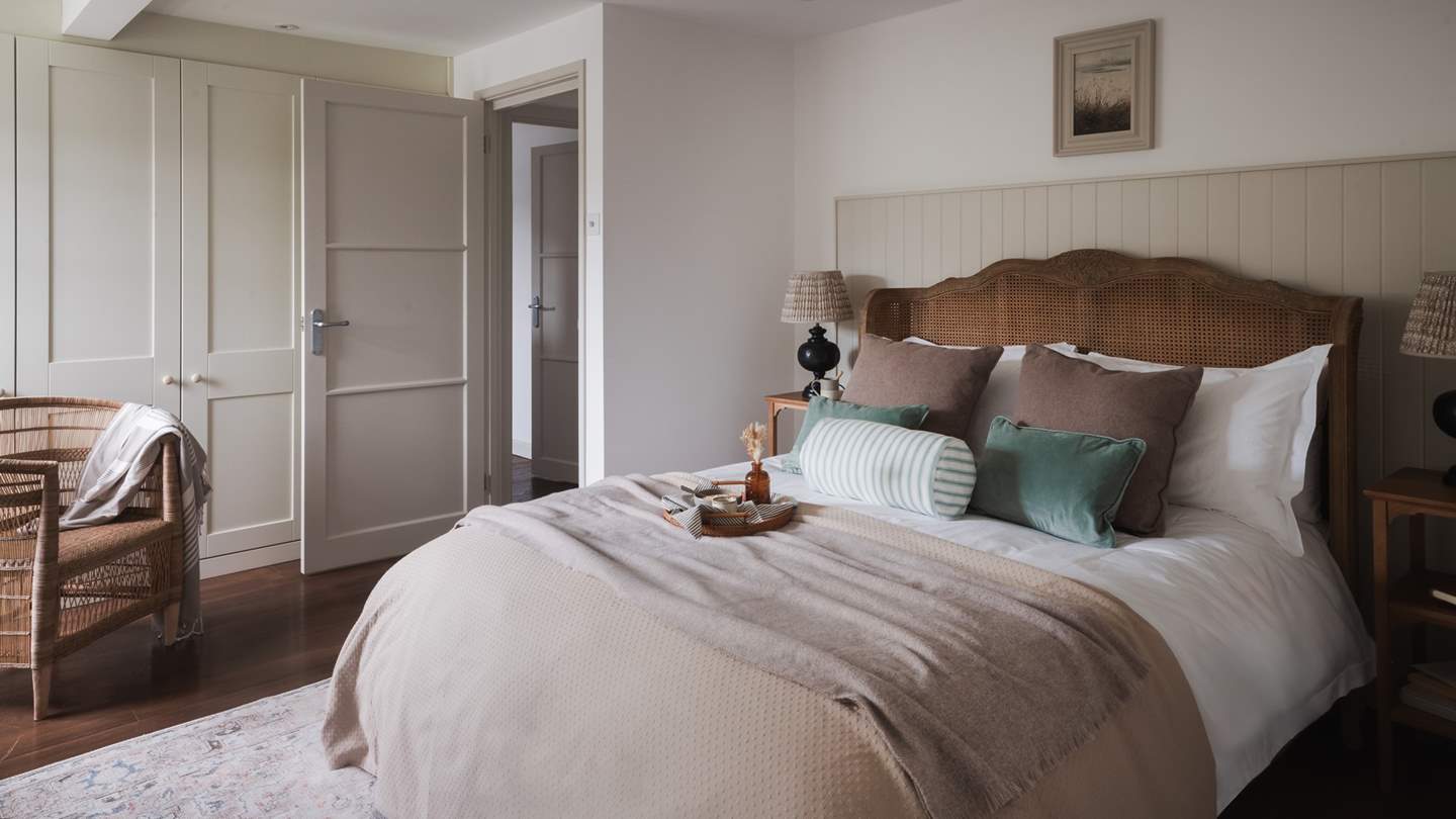 Residing on the first floor, the master bedroom stars a beautiful Feather & Black bed 