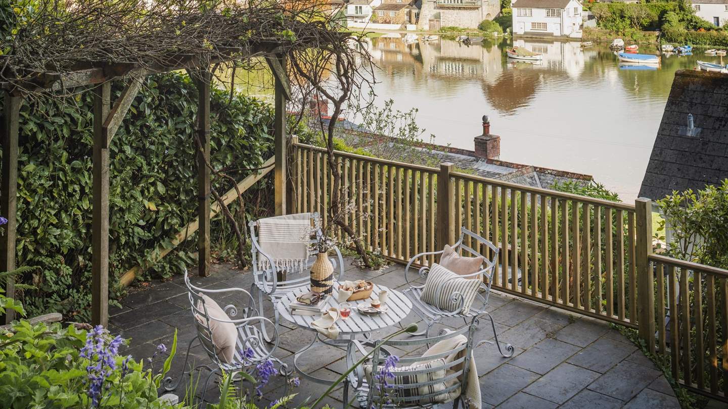 For a tale of two halves, the back garden imbues a magical woodland feel and provides additional space for relaxing and socialising with an informal table and chairs