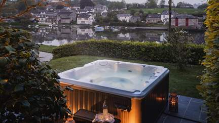 A heavenly hot tub resides at Ophelia, just made for serene staycation moments overlooking its mesmeric waterside setting